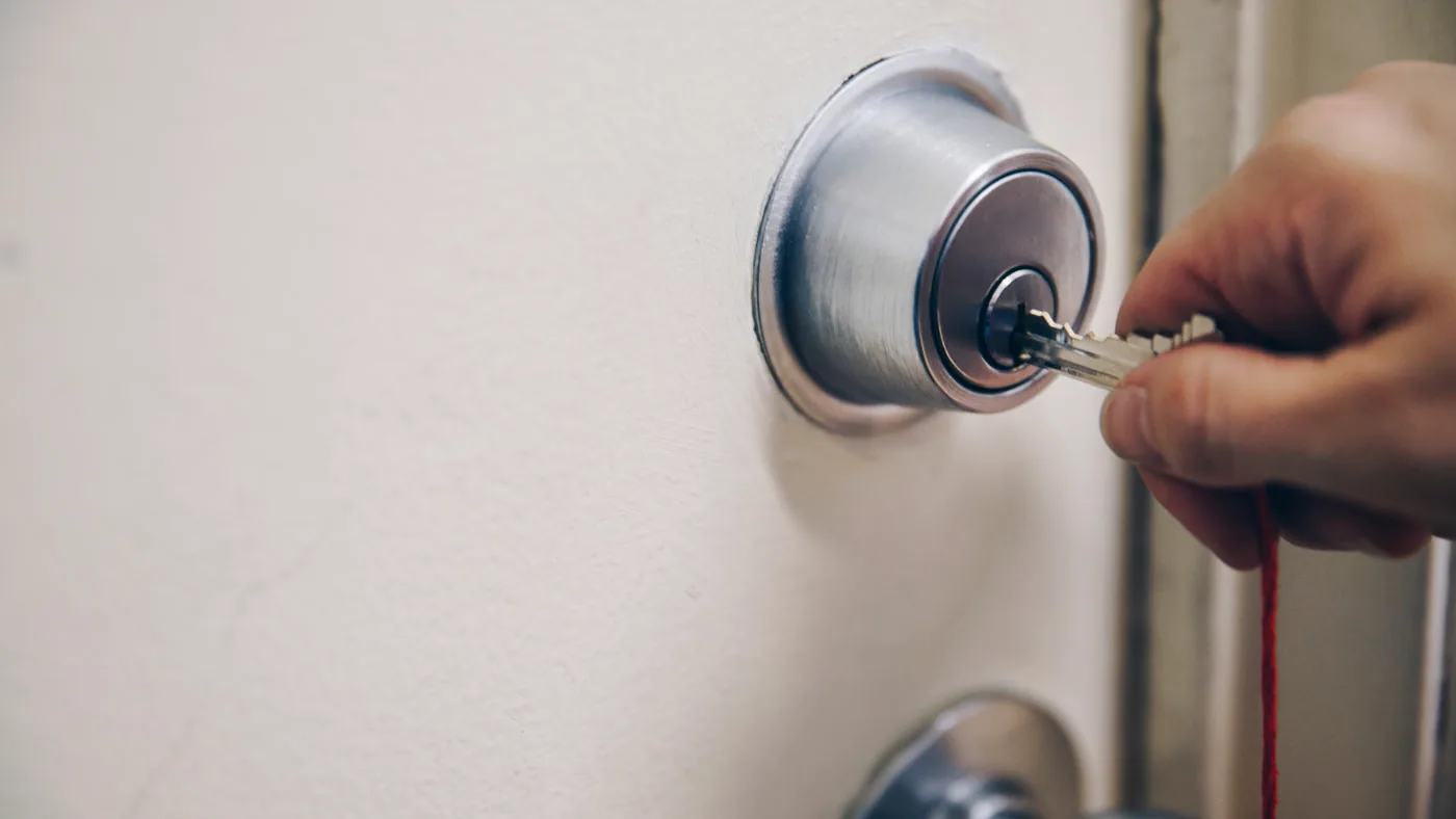 A key being used in a domestic door lock